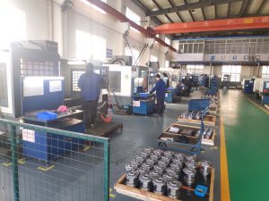 Real-time CNC machining scene at XLUIG, showing advanced 5-Axis equipment producing tight-tolerance components for diverse applications.