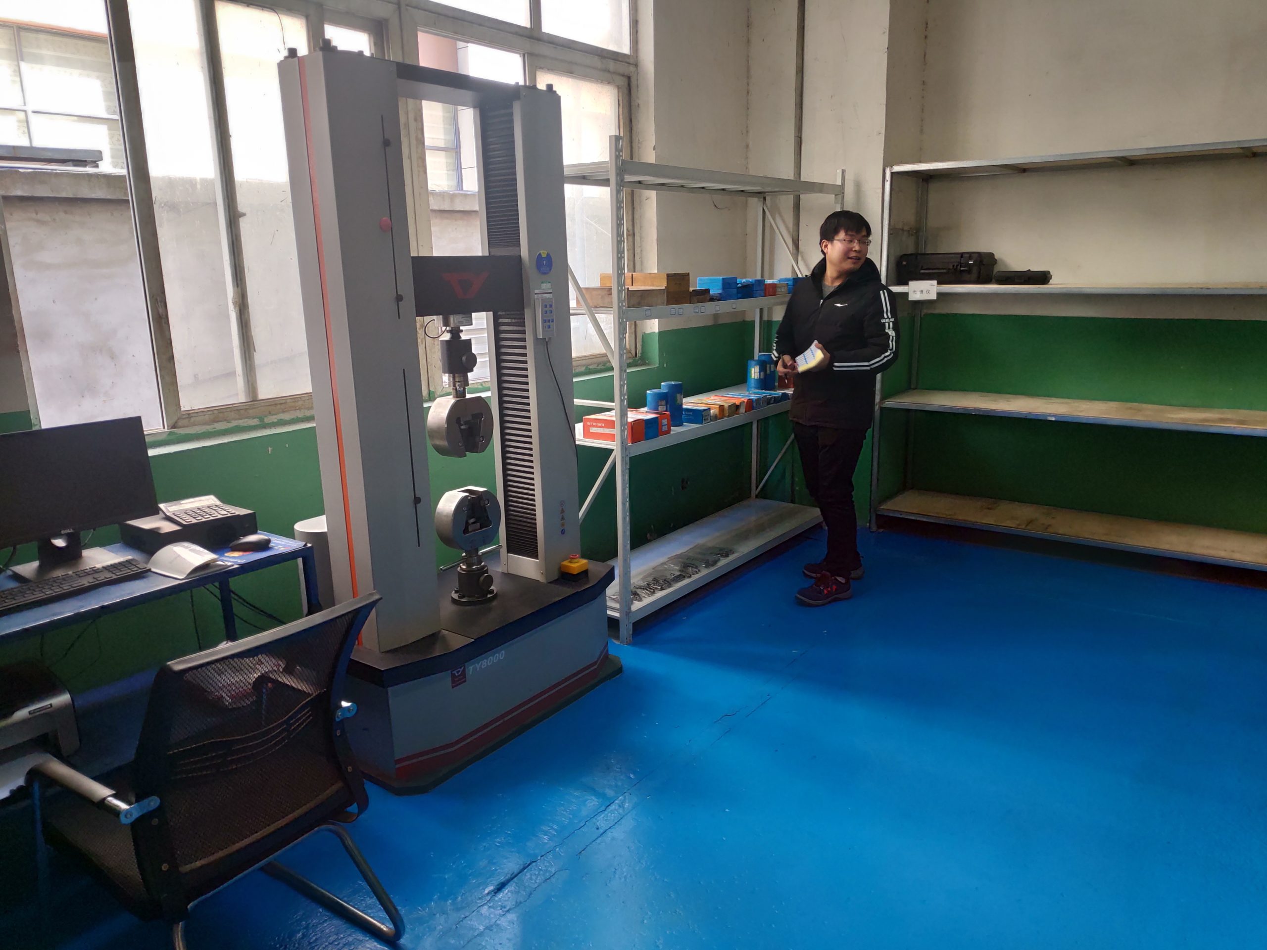 XLUIG quality control technician conducting random sampling inspection to verify conformity of finished industrial components.